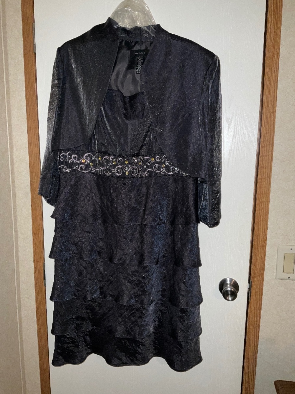 Dress is a charcoal grey. Size 16 brand R & M Richards